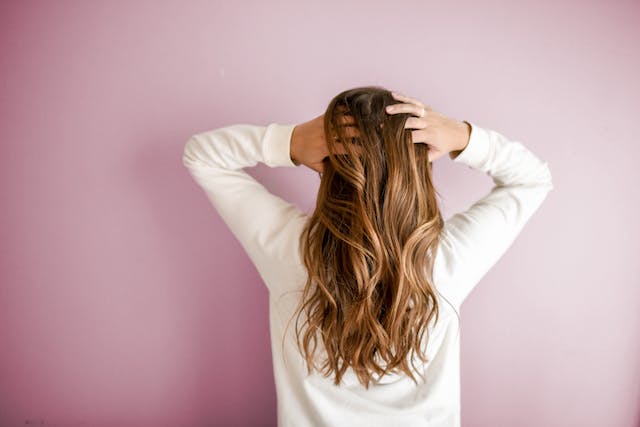 A woman brushing back her hair