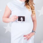 pregnancy photoshoot, women holding picture of baby ultrasound