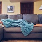 A person sleeping on the couch.