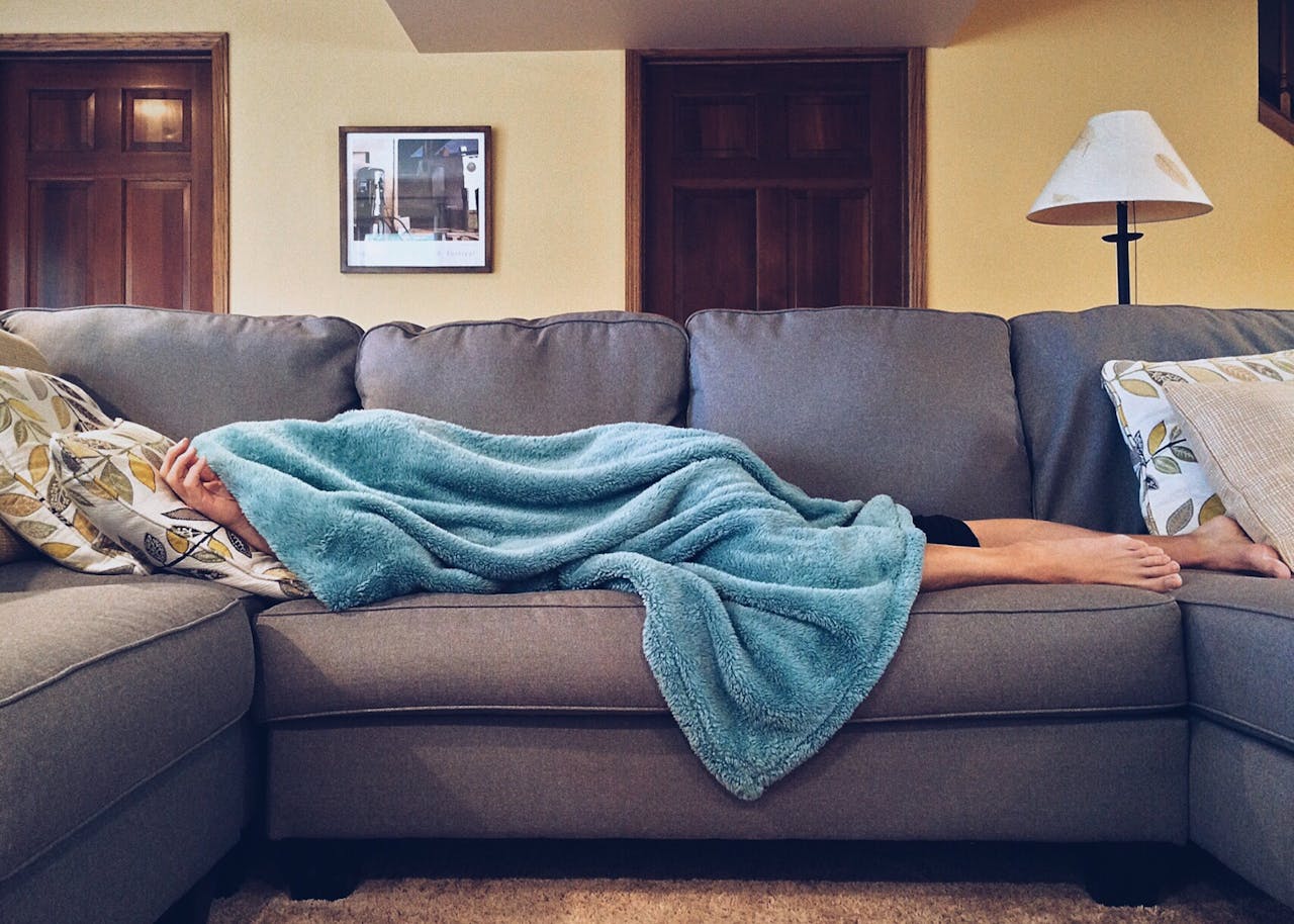 A person sleeping on the couch.