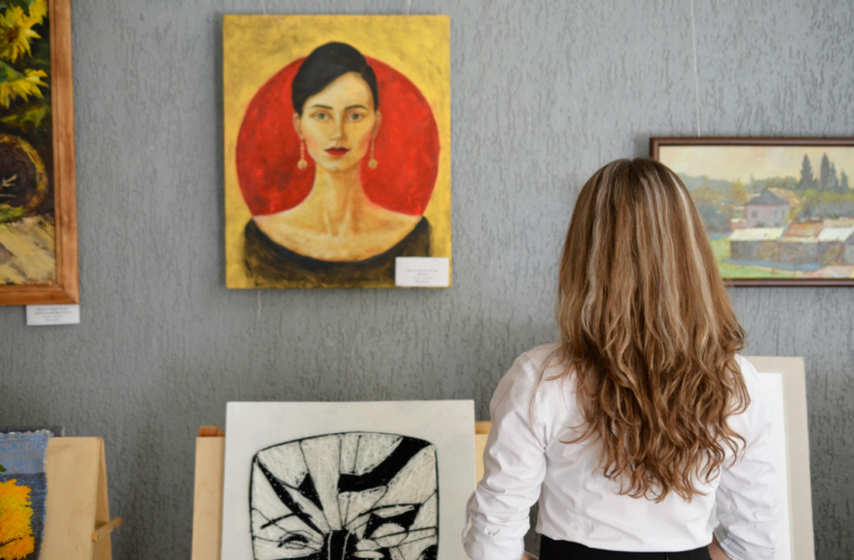 Woman appreciating paintings in an art gallery