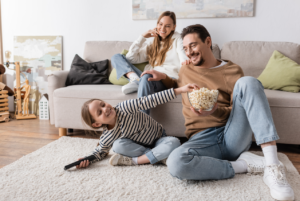 family laughing and watching a movie together