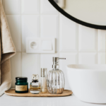 Bathroom countertop and sink with a range of toiletries.