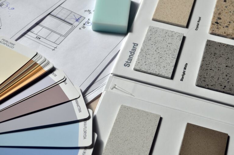 A display of various paint shades and ceiling tile options, as would be used when planning a remodel.