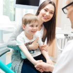 Parent with toddler child on a dentist appointment.