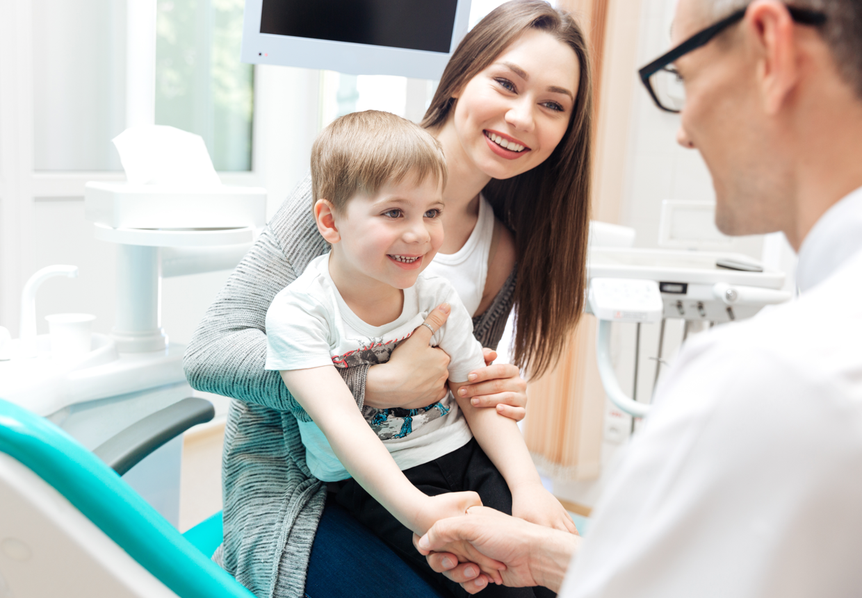 Parent with toddler child on a dentist appointment.