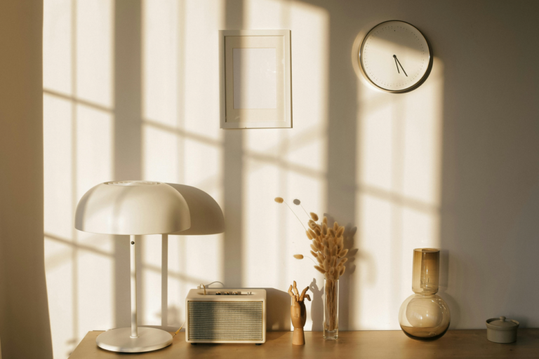 Neutral home decorative items lined up on a table.