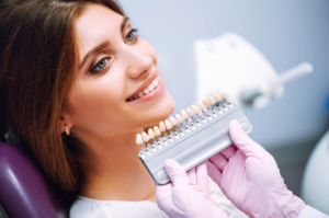 Lady smiling to find a color match for her veneers.