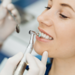 Lady's teeth being cleaned by a dental professional.