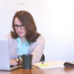 A woman working on the computer.