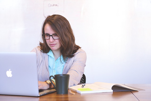 A woman working on the computer.