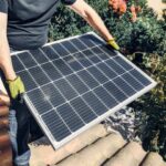 Person holding a solar panel