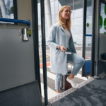 A lady entering an airport shuttle bus.