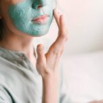 Woman putting on a face mask