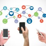 digital composite of hands using smartphones with graphics