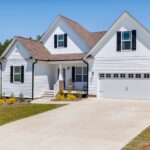Modern single-family home with an attached garage and paved driveway.