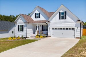 Modern single-family home with an attached garage and paved driveway.