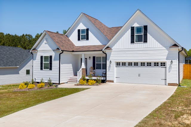 Modern single-family home with an attached garage and paved driveway.
